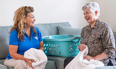 A Visiting Angels caregiver assisting an elderly man with daily activities, demonstrating personalized support in home care services.