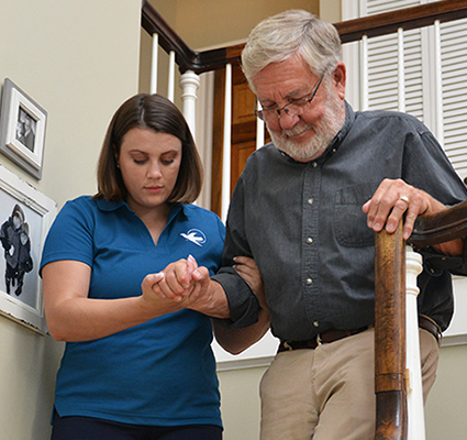 A Visiting Angels caregiver engaging with an elderly man outdoors, highlighting the warmth of in-home care services.